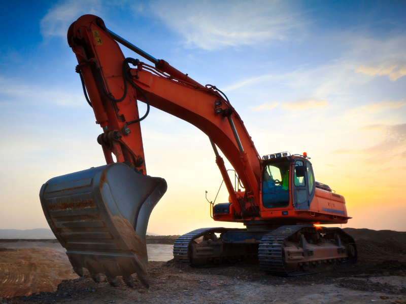 A large orange excavator at a construction site