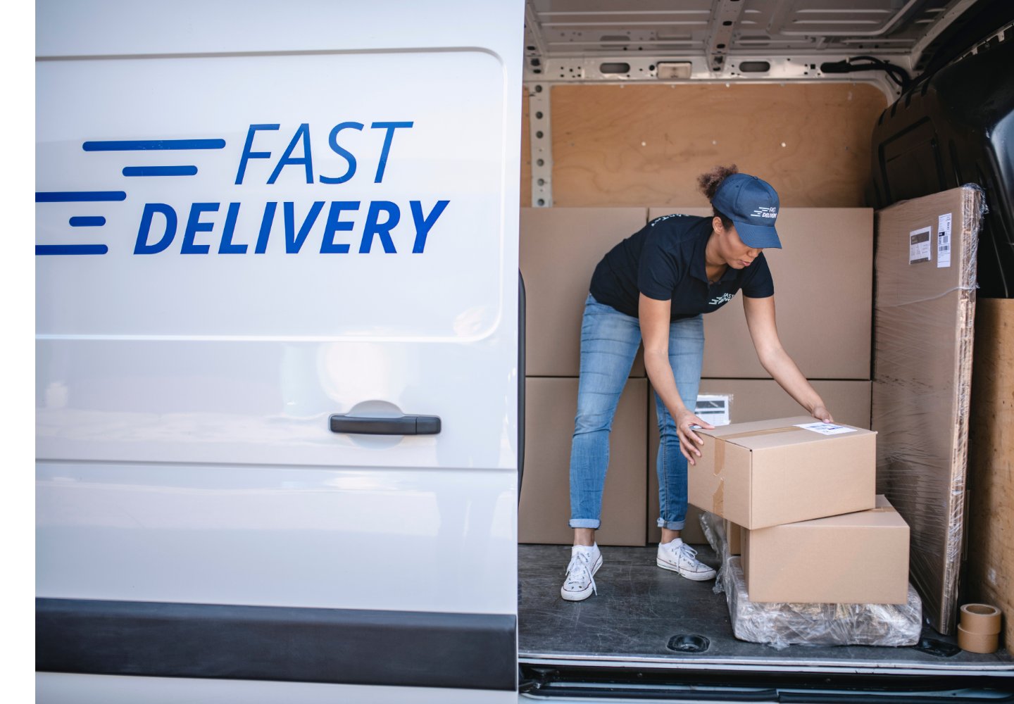 Delivery business owner loading a branded van, the type of business vehicle used as security in this bridging loan case study