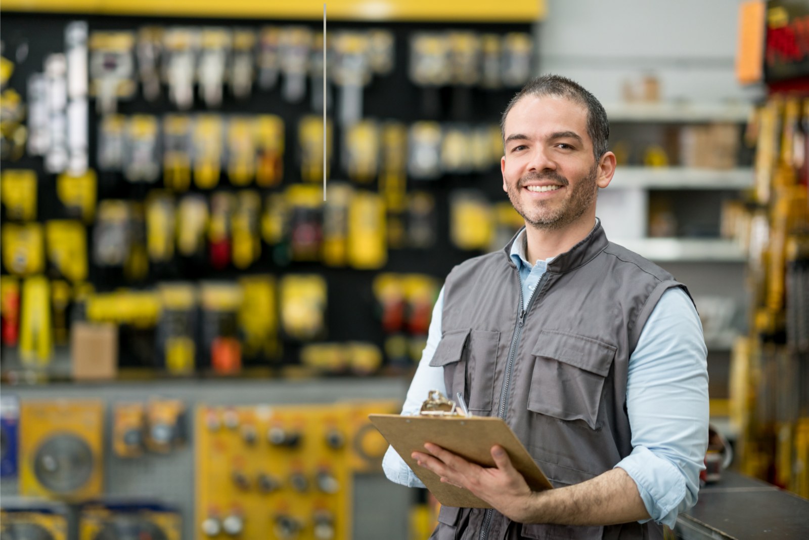 Hardware and power tools retail business owner reviewing stock, funded with a $250,000 business line of credit
